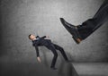 Giant foot in black shoe kicking little businessmen off the edge, and he is falling down