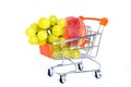 Giant fruits in a shopping cart, trolley on a white background.