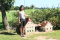 Giant girl standing by mill in Minimodel of South Bohemian village