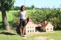 Giant girl standing by mill in Minimodel of South Bohemian village