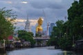 The Giant Golden Buddha in Wat Paknam Phasi Charoen Temple in Phasi Charoen district with boat on Chao Phraya River at night,