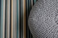 Giant gray pillow woolen knitted on striped carpet Bedroom. Interior Scandinavian Design