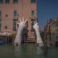 The giant hands of the `Support` art piece in the Grand Canal in Venice