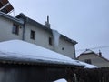 A giant hanging icicle from the snowy roof of the family home in the village