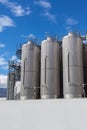 Giant industrial tanks on the bright blue sky