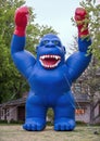 Giant inflatable blue and red gorilla standing in a yard in Oklahoma City.