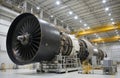 Giant jet engine inside aerospace facility. Advanced technology jet engine components undergoing testing and assembly. Futuristic Royalty Free Stock Photo