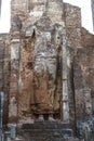 A giant masoned standing Buddha statue without head in a temple in the royal ancient city of Polonnaruwa in Sri Lanka Royalty Free Stock Photo