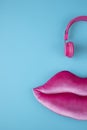 Giant mauve lips made of plush with pink headphones Royalty Free Stock Photo