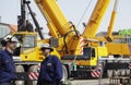 Giant mobile cranes and building workers Royalty Free Stock Photo