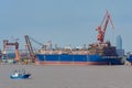 Giant new building gas tanker on shipyard.
