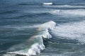 Giant ocean waves crash on the water surface forming a rainbow Royalty Free Stock Photo