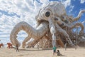 Giant Octopus Sculpture on Sandy Beach, An oversized playground in a land of giants, AI Generated Royalty Free Stock Photo