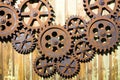 GIANT OLD AND RUSTY COGWHEELS ON THE WALL