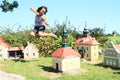 Giant girl hitting belfry in Minimodel of South Bohemian village