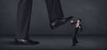 Giant person stepping on a little businessman concept Royalty Free Stock Photo