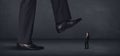 Giant person stepping on a little businessman concept Royalty Free Stock Photo