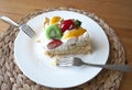 Giant piece of cake on the white dish with 2 tea spoons.