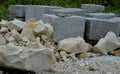 Giant pile of rolling stone blocks. boulders for sale. cleaning large rivers with ground stones. the loader gives them to gardener