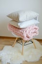 Giant Pink Blanket Woolen Knitted on White Wooden Stool Chair Royalty Free Stock Photo