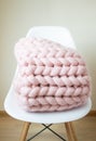 Giant Pink Plaid Blanket Woolen Knitted on White Wooden Stool Chair Home Royalty Free Stock Photo