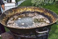 Giant pot with hot oil to fry delicacies during an outdoor party Royalty Free Stock Photo