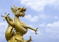 Giant Powerful Golden Dragon Statue at The Corner with Blue Sky and Cloud in Background