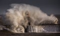 Giant waves batter the 15metre tall lighthouse which guards the south pier at the mouth of the Tyne at South Shields, England Royalty Free Stock Photo