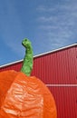 Giant pumpkin red barn blue sky Royalty Free Stock Photo