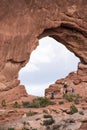 Tourists climb around in an arch inside of Arches National Park in Utah