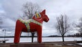 Dalarna horse in front of Saxviken part of lake Siljan in Mora, Sweden Royalty Free Stock Photo