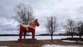 Dalarna horse in front of Saxviken part of lake Siljan in Mora, Sweden Royalty Free Stock Photo
