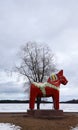 Dalarna horse in front of Saxviken part of lake Siljan in Mora, Sweden Royalty Free Stock Photo