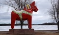 Dalarna horse in front of Saxviken part of lake Siljan in Mora, Sweden Royalty Free Stock Photo