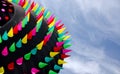 Giant ring shaped kite with colorful spikes over dunes of Ocean