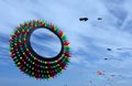 Giant ring shaped kite with colorful spikes over dunes of Ocean