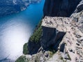 Giant rock Preikestolen over water of fjord Lysefjorden, natural attraction. Top view, flight above cliff. Preacher`s Pulpit or Royalty Free Stock Photo
