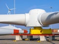 Giant rotors of wind turbine under clear blue sky
