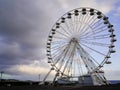 Giant round steel ferris wheel funfair park against cloud sky Royalty Free Stock Photo