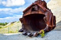 A giant rusty, excavator bucket.