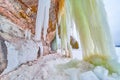 Giant sheets of icicles touching the ground next to cliffs Royalty Free Stock Photo
