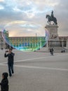 giant soap bubble hovering in front of the monument, knight D.JosÃÂ© I in the PraÃÂ§a do ComÃÂ©rcio in Lisbon.