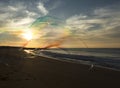 Giant soap bubble stretching across a beautiful beach at sunset in Portugal