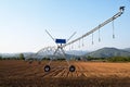 A giant spray sprinkler to irrigate a newly plowed field 604