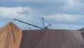 Giant spreader or absetzer machinery. A large dumper on a landfill with potash ore. Extracting potassium salts.