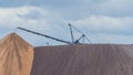 Giant spreader or absetzer machinery. A large dumper on a landfill with potash ore. Extracting potassium salts.