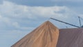 Giant spreader or absetzer machinery. A large dumper on a landfill with potash ore. Extracting potassium salts.