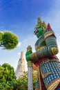 Giant statue of a god protecting the entrance to the wat arun temple, Thailand