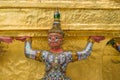 The giant statue supporting golden pagoda in the temple of the Emerald Buddha (Wat Phra Kaew) , Bangkok, Thailand Royalty Free Stock Photo