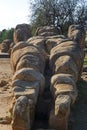 Giant statue of talamone from Zeus temple. And in background view on the town of Agrigento. Royalty Free Stock Photo